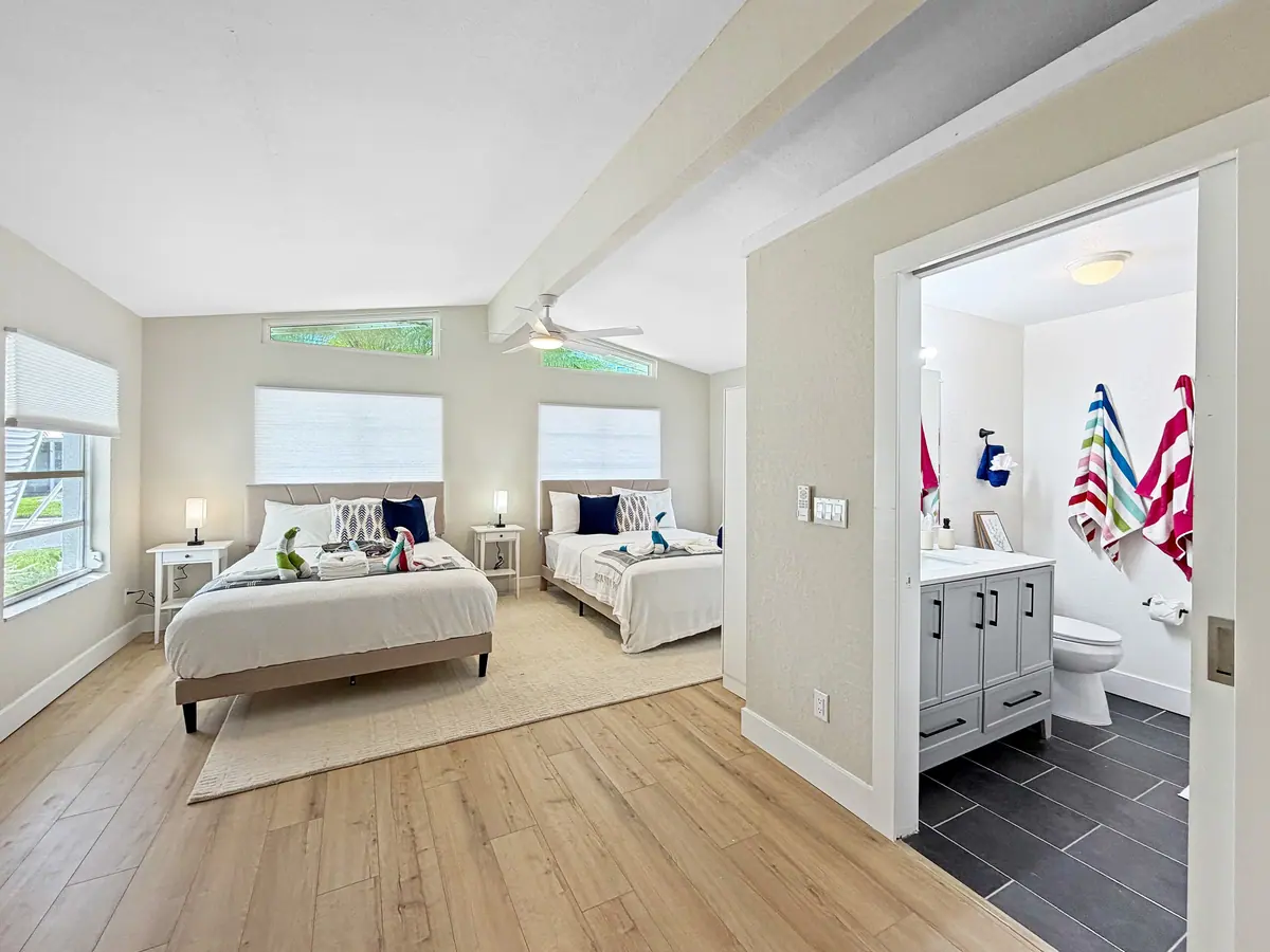 Bedroom with two beds and an adjoining vanity area.