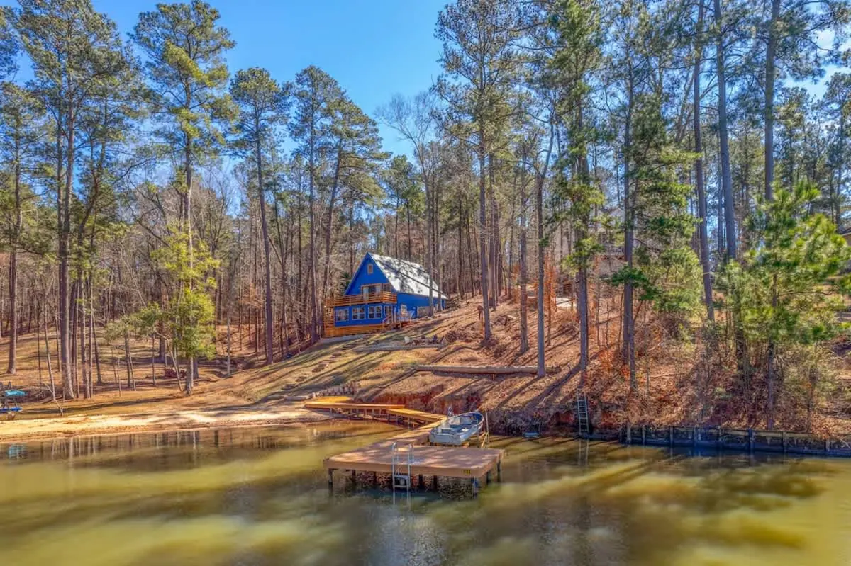 Aerial view of the cabin above its own stretch of shoreline and dock on Lake Sinclair.