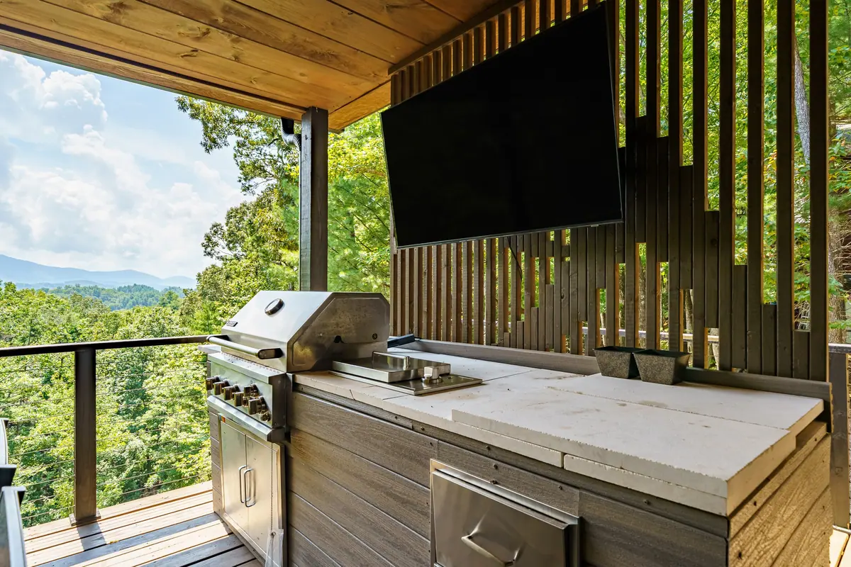 Built-in gas grill on the upper deck, with the valley opening out behind it.